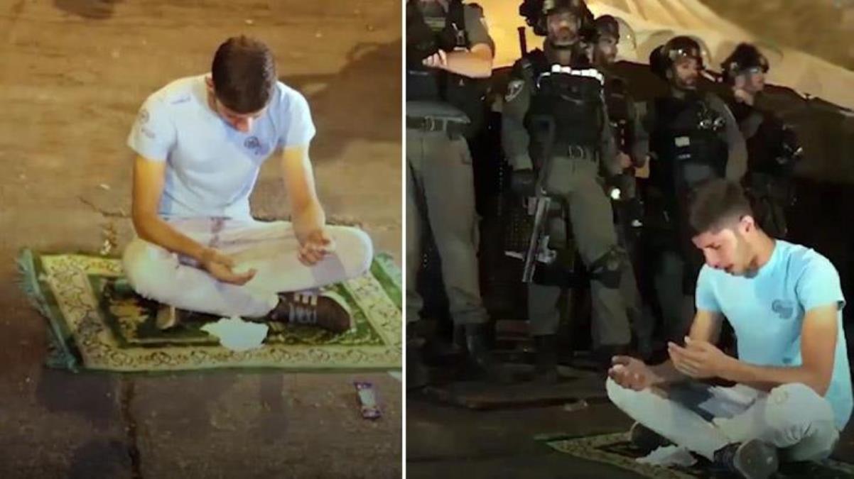 Filistinli genç, polis barikatlarının ortasında seccadesine oturup bağırarak yalvardı: Allah'ım yardım et